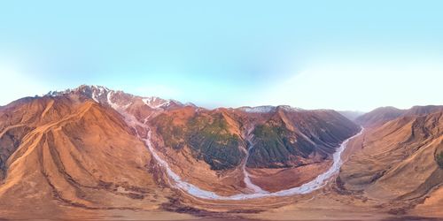 Scenic view of mountain range against blue sky