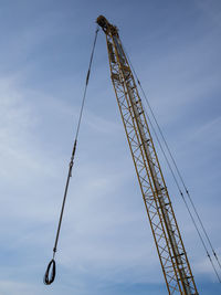 Low angle view of crane against sky