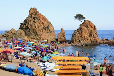 Panoramic view of people on beach against clear sky