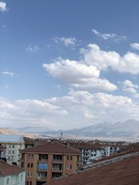 Buildings in town against sky