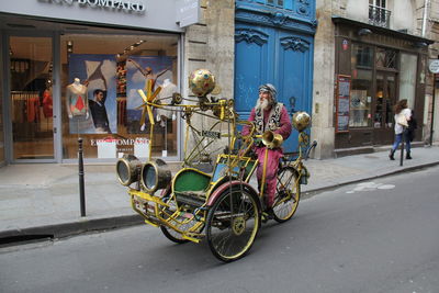 Bicycles on road by buildings in city