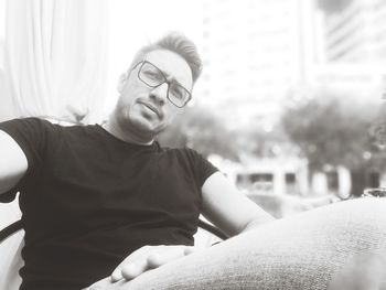 Portrait of young man sitting outdoors