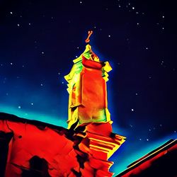 Low angle view of clock tower against sky at night