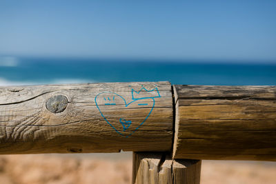 Close-up of wooden post against sea