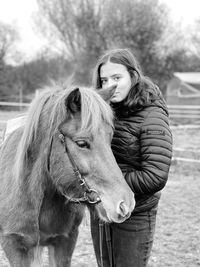 Portrait of young woman riding horse