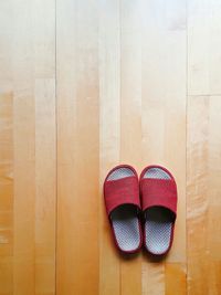 Close-up of footwear on wooden floor
