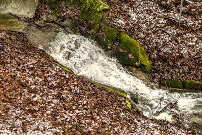 High angle view of waterfall by river