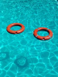 High angle view of red floating on swimming pool