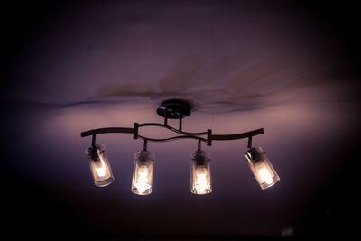 Low angle view of illuminated light bulb hanging