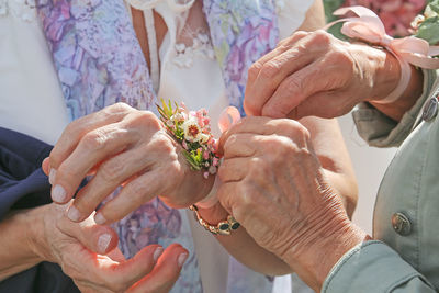 Cropped hands of woman holding bouquet