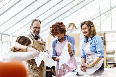 Laughing mature business owners with textile samples