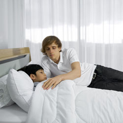 Mother and son on bed