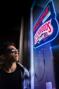 Woman looking at illuminated sign