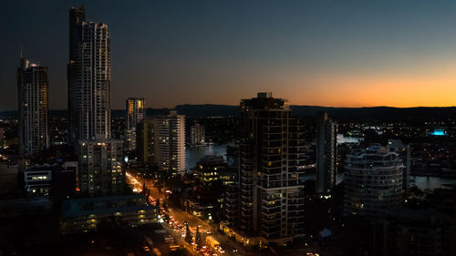 High angle view of city lit up at night