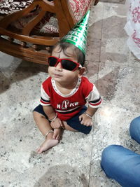 High angle view of boy sitting in sunglasses