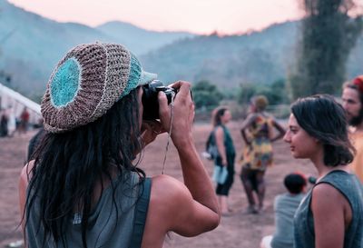 Rear view of woman photographing