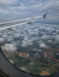 Aerial view of clouds seen through airplane window