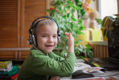 Portrait of cute smiling boy wearing headphones