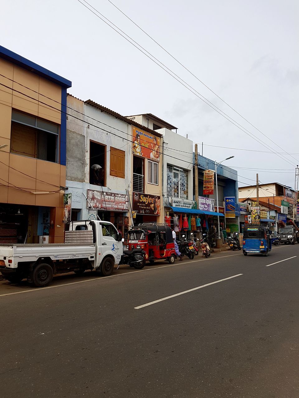 CARS ON ROAD AGAINST BUILT STRUCTURES