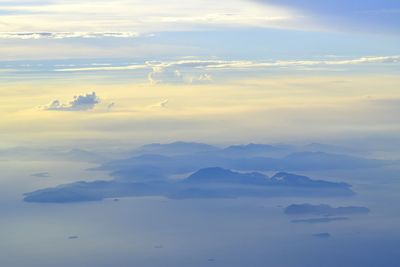 Aerial view of clouds over landscape during sunset