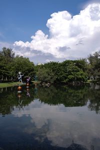 Reflection of trees in lake against sky