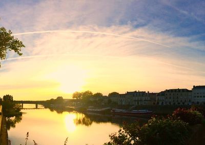 Scenic view of river at sunset
