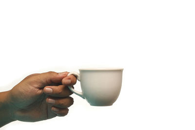 Midsection of person holding coffee cup against white background