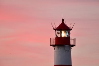 Low angle view of lighthouse against sky during sunset