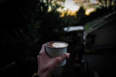 Person holding coffee cup