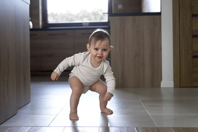 Playful girl standing on floor