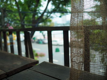 Close-up of wooden table by window