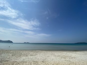 Scenic view of beach against blue sky