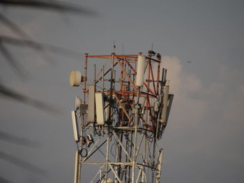 Low angle view of communications tower against sky