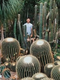 Portrait of man standing against plants