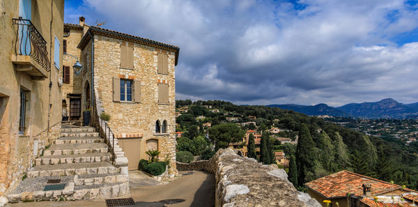 Buildings in town against sky