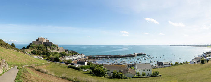 Panoramic view of sea and buildings against sky