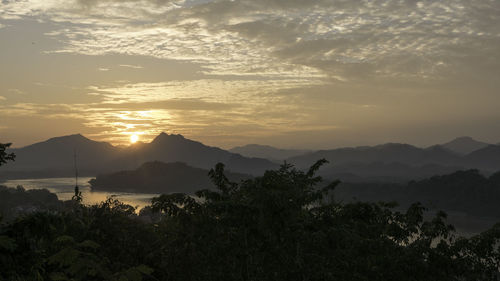 Scenic view of mountains against sky at sunset