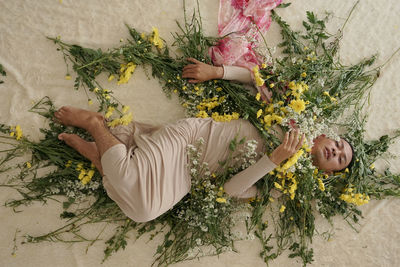 Low section of woman holding bouquet