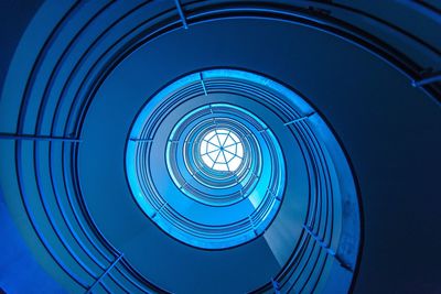 Directly below shot of spiral staircase against skylight