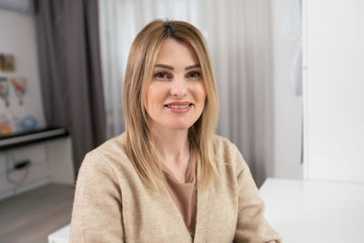 Portrait of young woman looking away at home