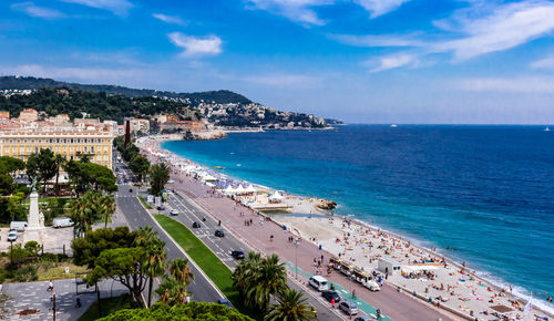 High angle view of town by sea against sky