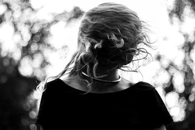 Woman tossing hair in park