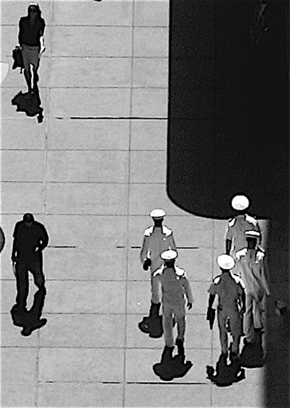 MEN STANDING ON THE ROAD