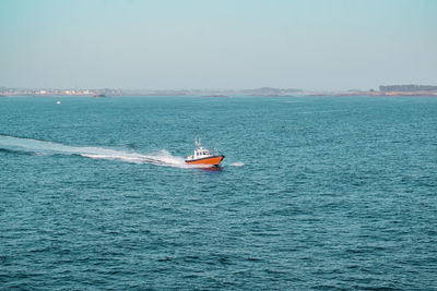 Pilot boat approaching from the coast across the sea