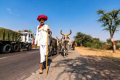 Rear view of person on road against sky