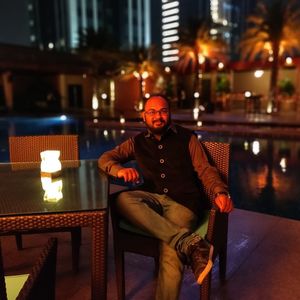 Portrait of man sitting on chair at night