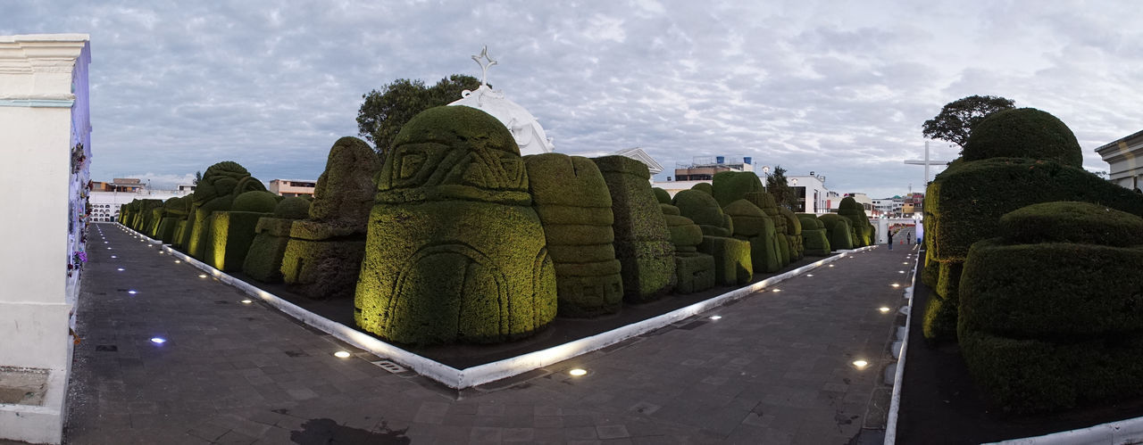 PANORAMIC VIEW OF STATUE AND PLANTS AGAINST SKY