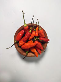 Close-up of red chili pepper against white background