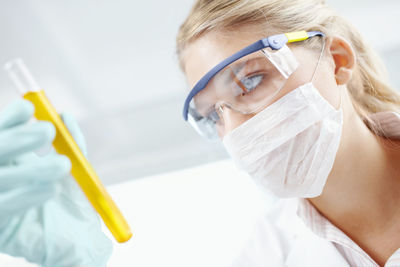 Close-up of female scientist examining patient in laboratory
