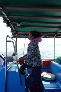 Full length of woman standing against sea